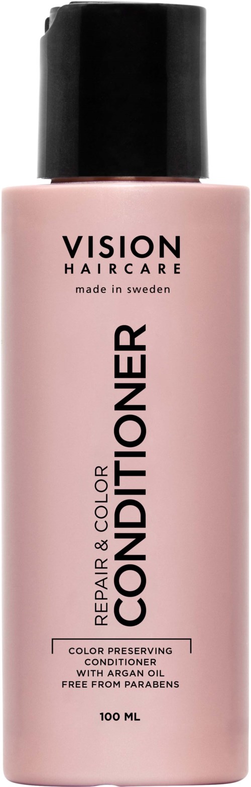 Eine rosa Flasche mit schwarzem Deckel, beschriftet "Vision Haircare" und "Conditioner," für Haarpflege.