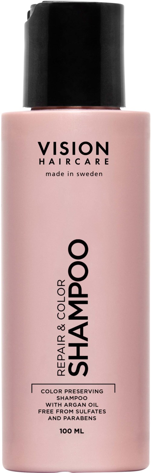 Pink shampoo bottle labeled 'Vision Haircare' with black cap, mentioning repair, color preservation, and natural oils.