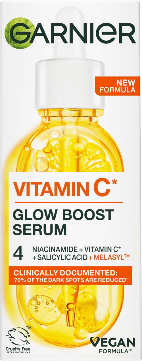 Garnier Vitamin C serum bottle with orange labels and a yellow liquid inside. Blue and white background. Highlights ingredients and benefits.