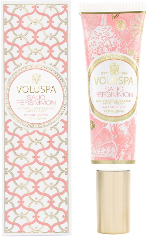 Ein rosa marmorierter Tube von Voluspa Sault Persimmon Handcreme neben seiner dekorativen Box.