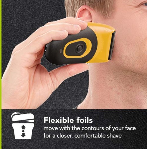 A person uses a yellow and black device with a camera to shave closer, smoother. Flexible foils help move with face contours.