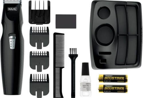 An electric hair trimmer with multiple attachments, combs, oil, batteries, and a storage case.