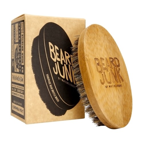 A wooden brush with the words 'BEAR JUNK' engraved on it, and a box with the same logo. The brush has black bristles.