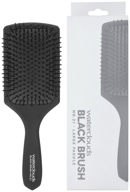 Eine schwarze Haarbürste mit ovaler Form und vielen Borsten, neben der Verpackung.