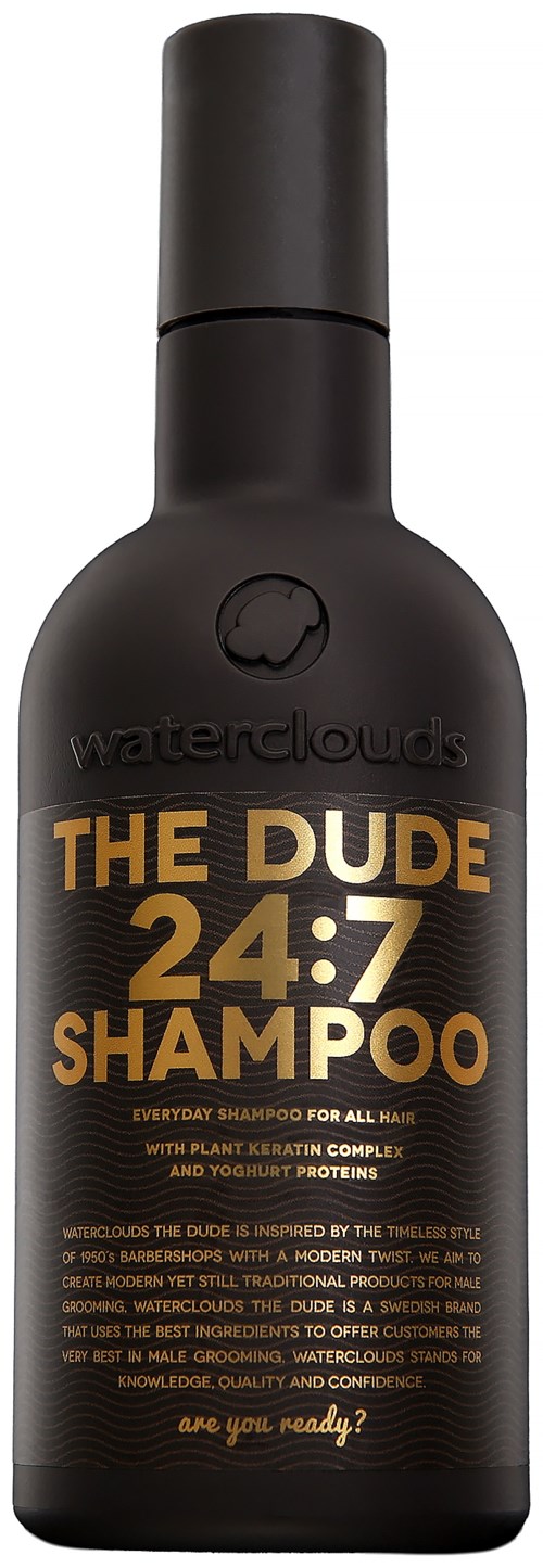 Black shampoo bottle labeled "The Dude 24:7 Shampoo" for all hair types, with plant-based content and modern design.