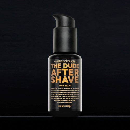 Black bottle with orange and white text for a men's after shave product, called "The Dude After Shave."