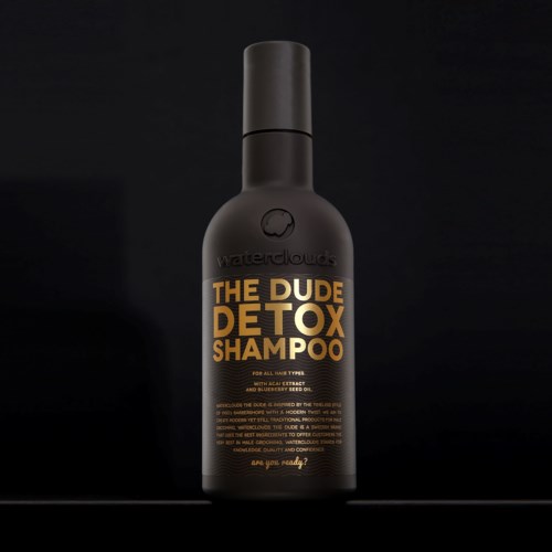 Eine schwarze Flasche mit 'The Dude Detox Shampoo' in gold- und weißen Buchstaben, schwarzer Deckel.
