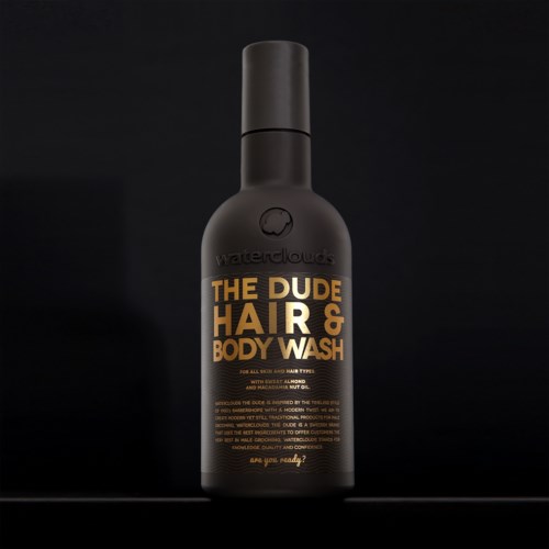 A black bottle of Waterclouds The Dude Hair & Body Wash with orange and white text, standing against a black background.