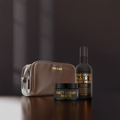 A men's grooming set with a toiletry bag, hair and body wash, and matte cream paste in black containers.