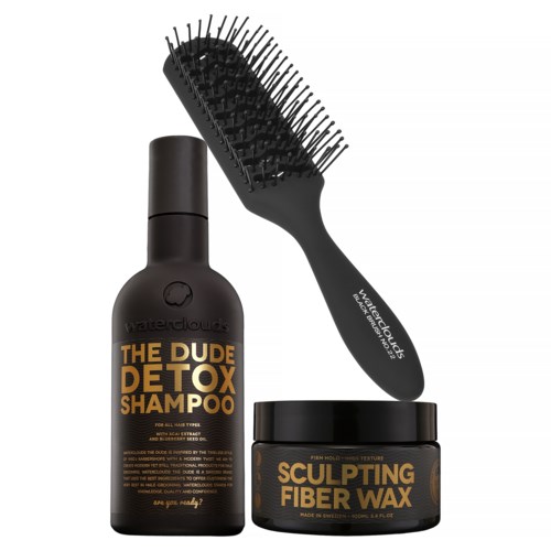 Eine schwarze Flasche mit Detox-Shampoo und ein schwarzer Behälter mit Sculpting Fiber Wax, mit einer Haarbürste.