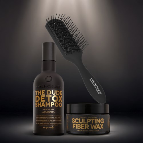 Eine schwarze Flasche mit Detox-Shampoo, ein runder Behälter mit Sculpting-Faserwachs und eine Bürste mit gebogenem Design.