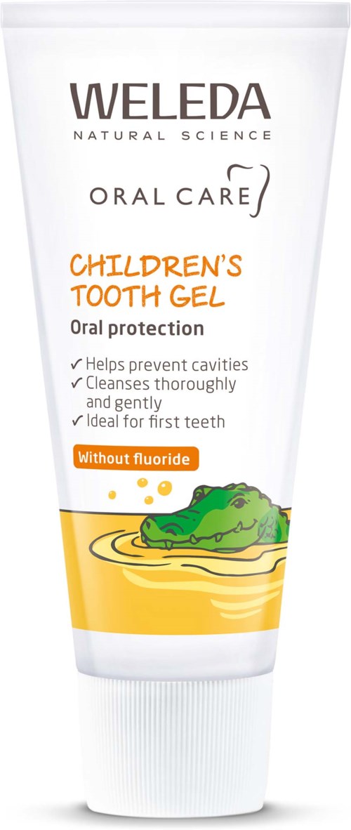 Eine Kinder-Zahnpasta Tube mit Krokodil-Illustration, zeigt sie ist fluor-frei und fördert saubere, gesunde Zähne.