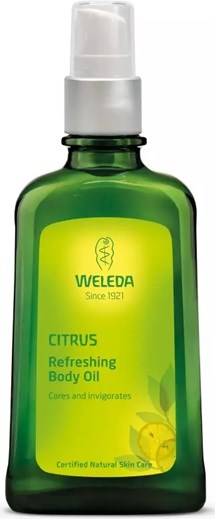 Eine grüne Flasche Weleda Citrus Refreshing Body Oil mit weißer Pumpe, als natürliche Hautpflege bezeichnet.