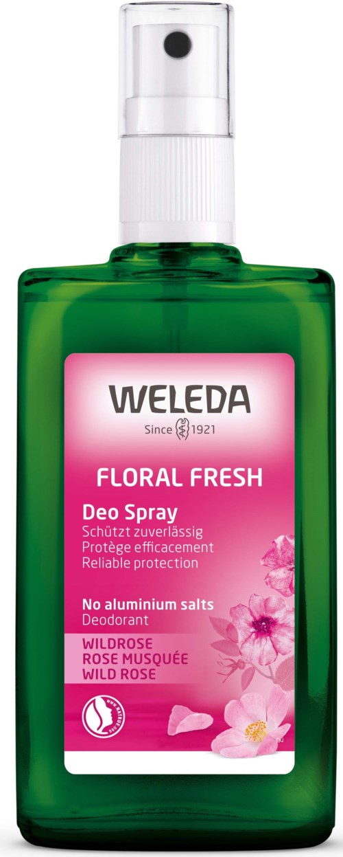 Green bottle with a spray top, pink label showing floral design, brand Weleda, floral fresh scent, for deodorant.