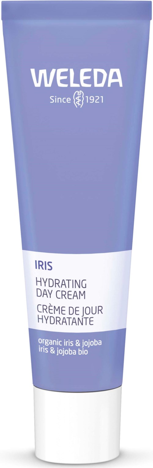 Eine blaue Tube von Weleda Iris Hydrating Day Cream mit weißen und lila Text, enthält biologische Iris und Jojoba.