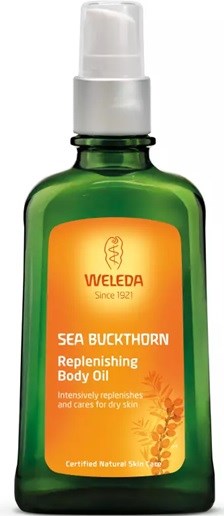 Eine grüne Flasche mit orangefarbenem Etikett mit Weleda Sea Buckthorn feuchtigkeitsspendendes Körperöl.