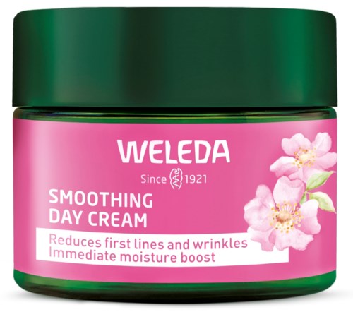 Roter Weleda-Topf mit Tagescreme, Blumen, grüner Deckel und Produktinformationen auf dem Etikett.