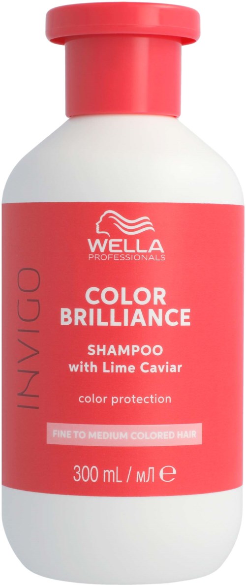 Een witte fles met een rood label en rood deksel, gelabeld Wella shampoo voor gekleurd haar met Lime Caviar.