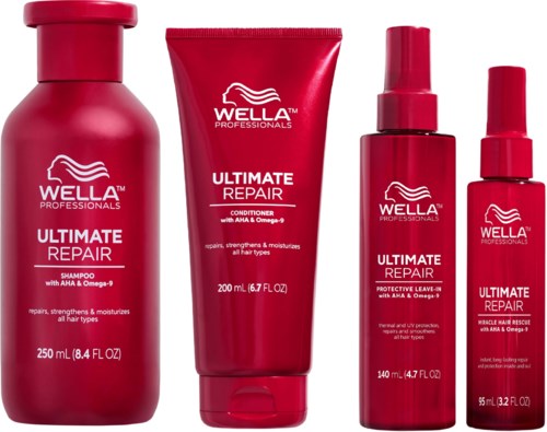 Four red hair care products, including shampoo, conditioner, leave-in spray, and serum, from Wella's Ultimate Repair line.