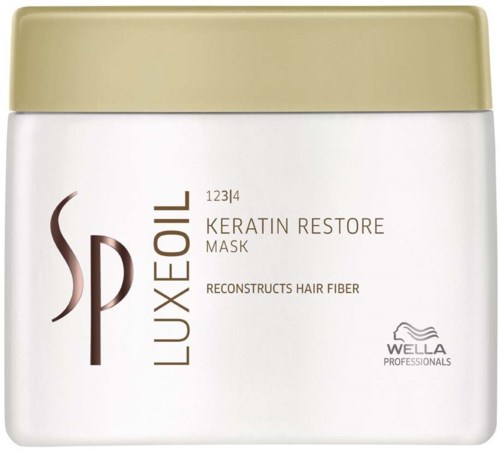Een witte pot met goudkleurige deksel, gemerkt 'LUXE OIL' en 'KERATIN RESTORE MASK' voor haarverzorging.
