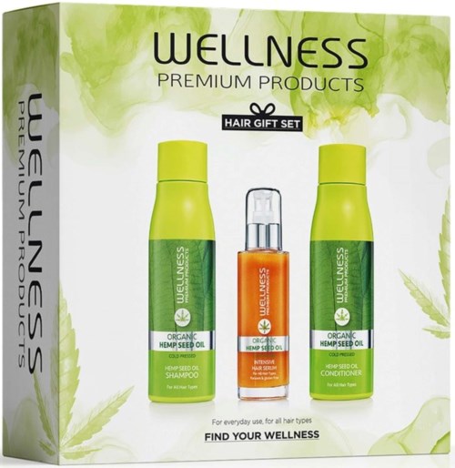 Green bottles and an orange bottle in a wellness hair gift set package.