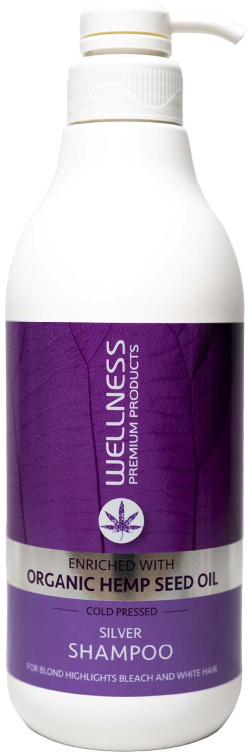Een witte fles WELNESS shampoo met een paarse etiket, vermeldt biologische hennepzaadolie en zilver voor blond haar.