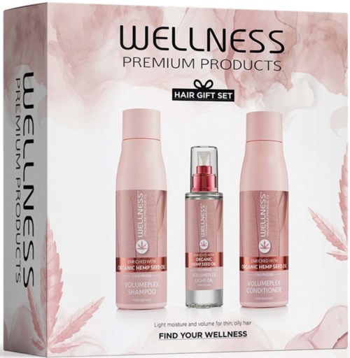 Set of three pink hair care bottles, including shampoo, conditioner, and serum, with wellness branding.
