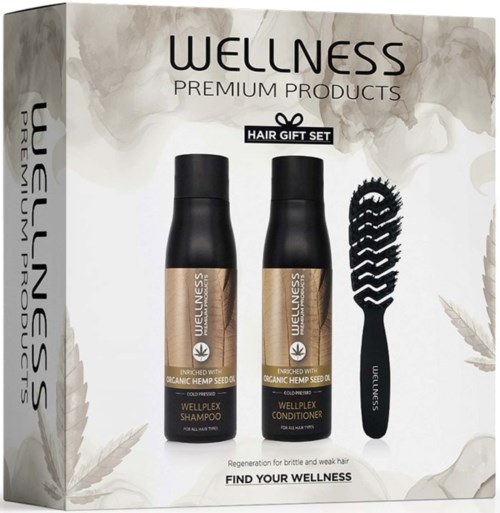 A wellness hair gift set with shampoo and conditioner bottles and a hairbrush, all in a box promoting natural hair care.