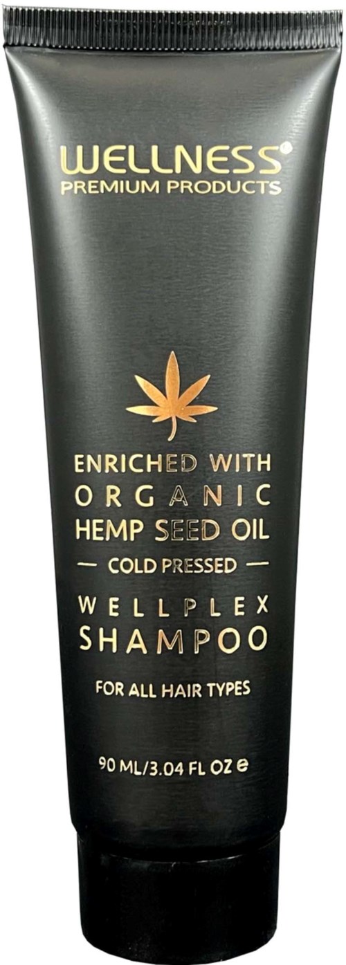 Zwarte tube met gouden en witte tekst die organische hennepzaadolie shampoo voor alle haartypes promoot.