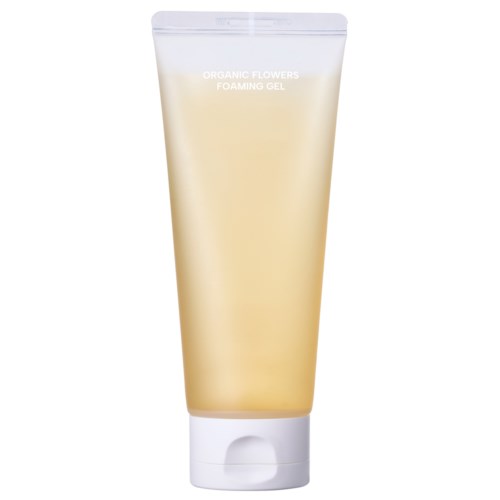 Ein beiger Tuben mit der Aufschrift 'Organic Flowers Foaming Gel' steht aufrecht, vermutlich ein Hautpflegeprodukt.