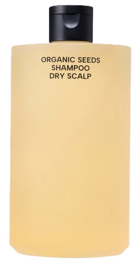 Ein schlichter gelber Shampoo-Flasche mit schwarzem Deckel, gekennzeichnet für trockene Kopfhaut, mit Bio-Samen-Shampoo.