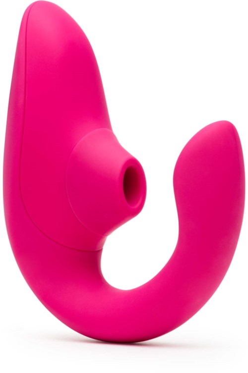 A pink, curved device with a hole in the middle, likely a personal massager or adult toy.