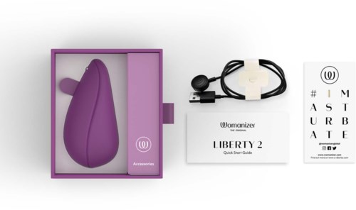 A purple personal massager, charger, quick guide, and an eye chart with the Womanizer logo on a white background.