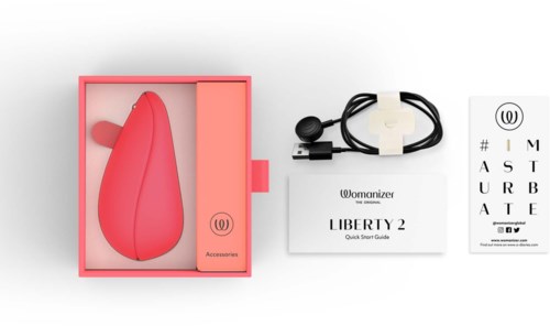 A pink device with a darker pink stripe, a charger, quick start guide, and an eye chart with instructions.