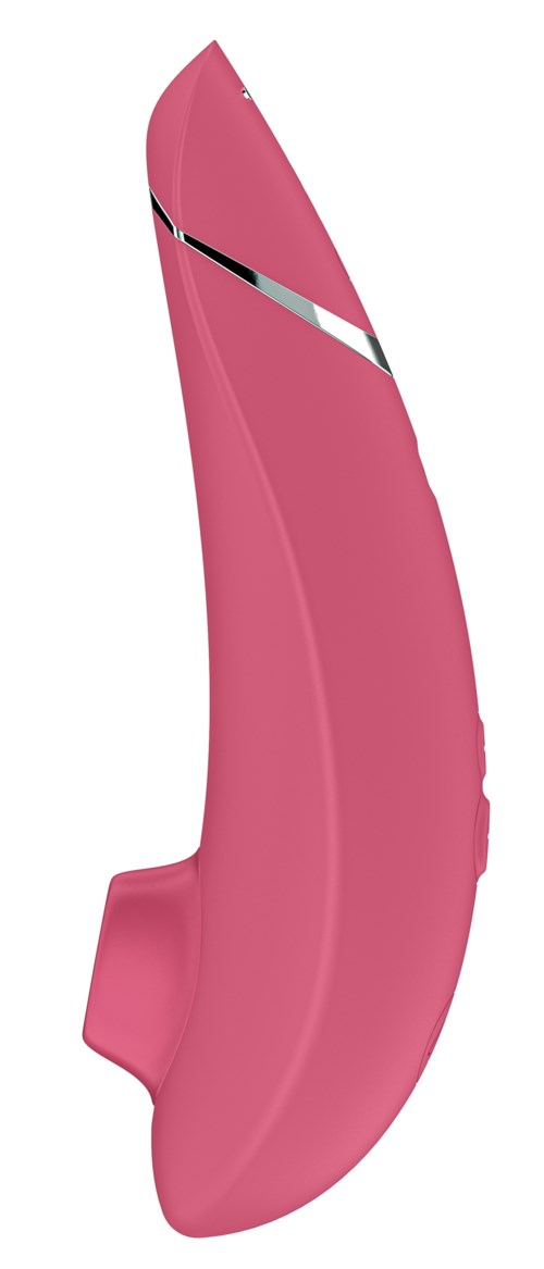 Ett rosa kurvat föremål med en svart och vit rand, ser ut som ett skärverktyg eller gadgets.