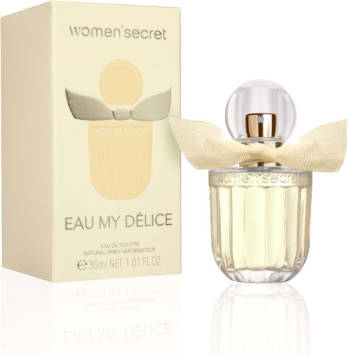 Eine Women's Secret Parfümflasche mit Schleife, neben der Verpackung, namens Eau My Délice, 30 ml, elegantes Design.