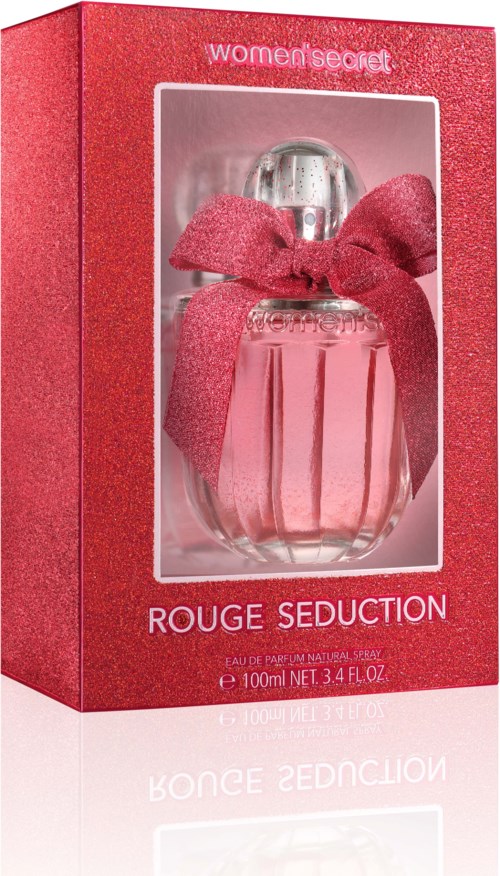 Een parfumfles in een rood doosje met een roze strik, genaamd 'Rouge Seduction' door Women Secret.