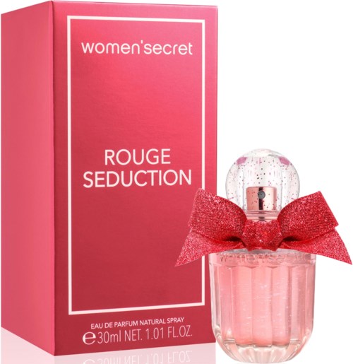 Een roze vrouwenparfumbox en fles met een grote rode strik op de fles.