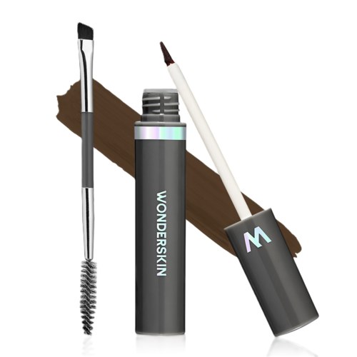 A grey eyebrow gel tube with a brush, a mascara wand, and a brown streak of makeup.