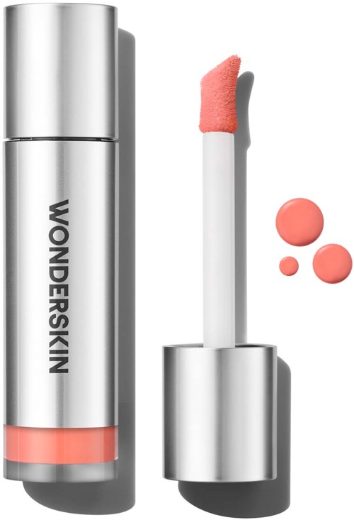 Lip gloss in a silver tube with the brand name Wonderskin, showing applicator with pink gloss and three pink dots.