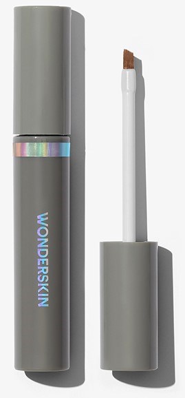 A grey stick with a holographic band, and a detachable applicator with a brown tip, labeled 'WONDERSKIN'.