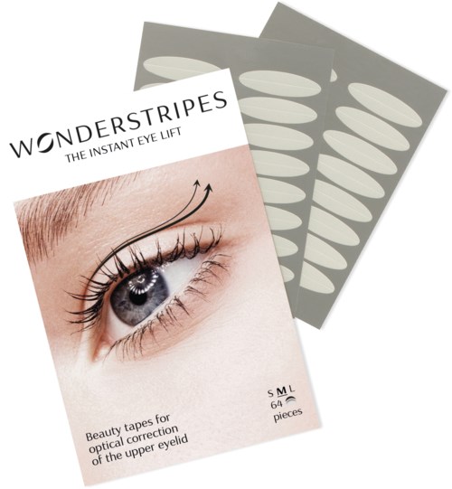 Een pakket met wimperliftingen tapes en een oogafbeelding op de voorkant, en vellen tape erachter.