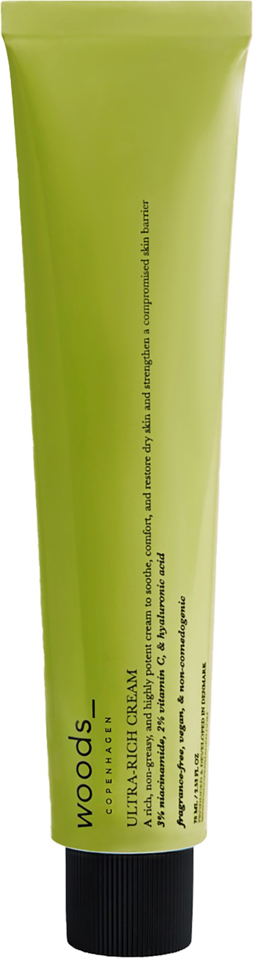 Grüne Tube mit schwarzem Verschluss, enthält ein Produkt namens 'Woods' für die Haut nach Rasur oder Haarentfernung.