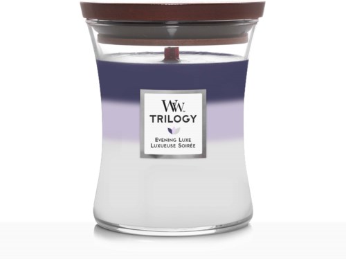 Et duftlys i glass med brun lokk, merket 'WW TRILOGY Evening Luxe'.