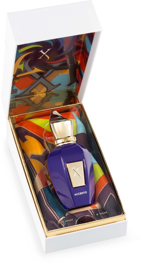 A perfume bottle inside a colorful box with abstract artwork and a gold cap.