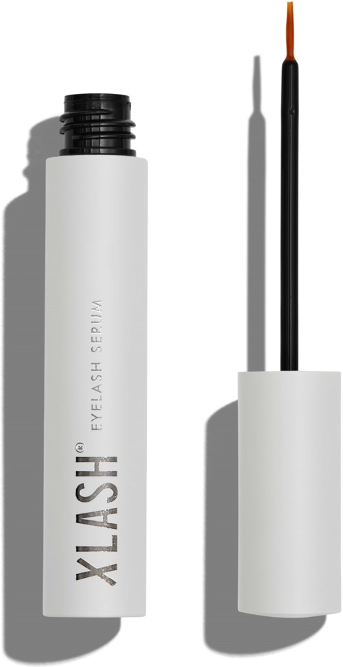 Een witte tube met zwarte dop en oranje kwast, waarschijnlijk een wimperserum of make-upproduct. Schaduw toont zonnig weer.
