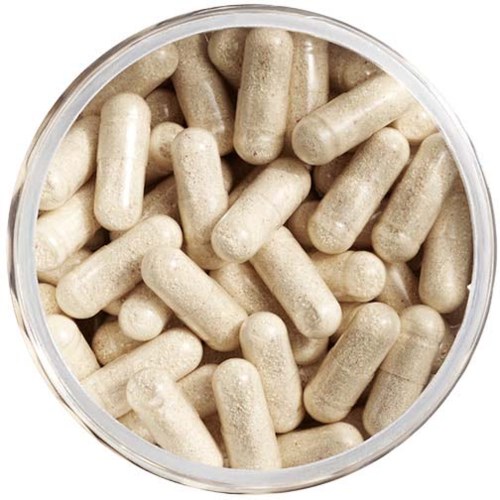 Small white capsules in a clear container, likely supplements or medication. Uniform shape and size.