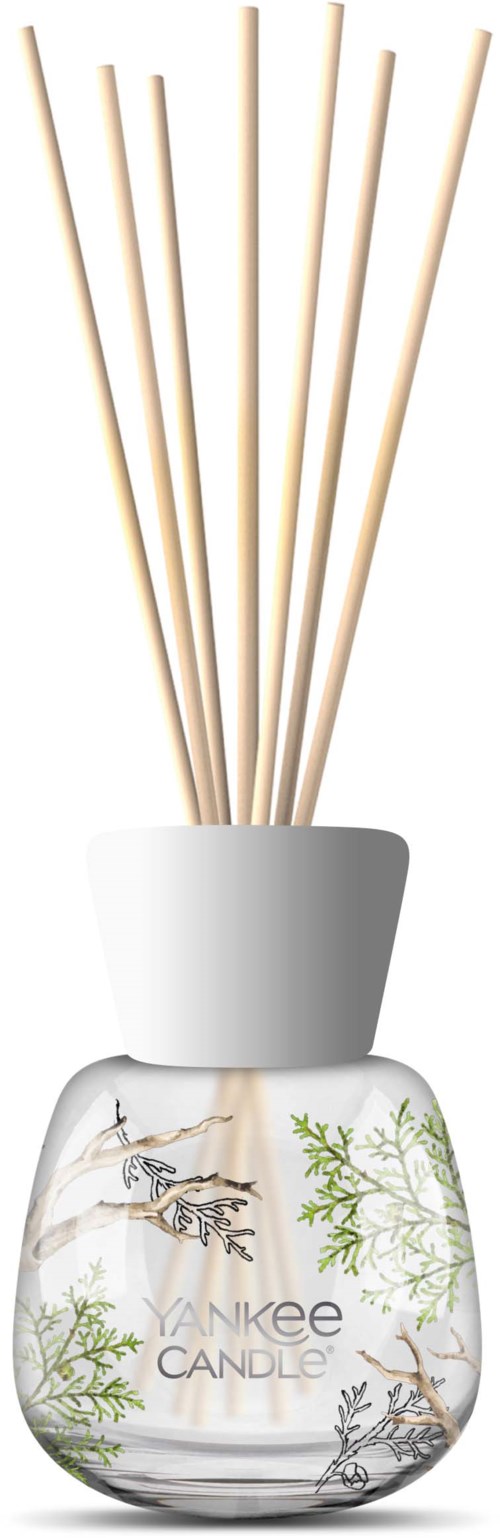 En Yankee Candle-duftdiffuser med trepinner og en dekorativ krukke med naturinspirerte illustrasjoner.