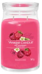 Pink candle with raspberry images and Yankee Candle label. It is in a glass jar.
