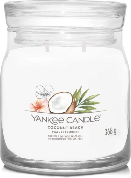 Ett transparent glasljus med kokosnöt och tropiska blommor, märkt 'Yankee Candle Coconut Beach,' väger 368g.